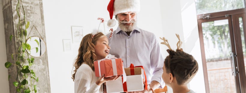 Grand father receiving gifts from grand kids