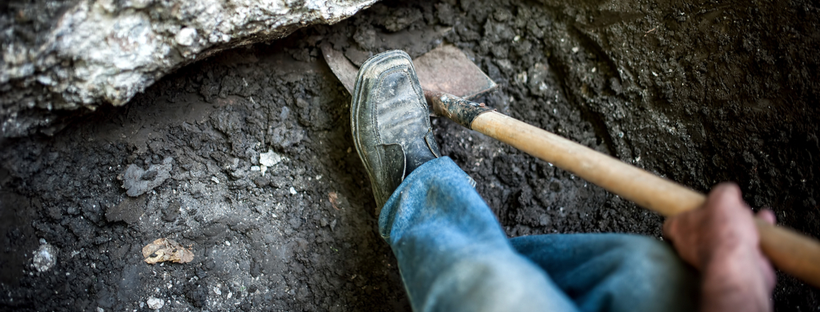 Man shoveling mud