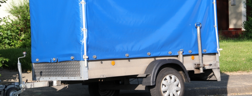 Heavy duty tarp covering trailer