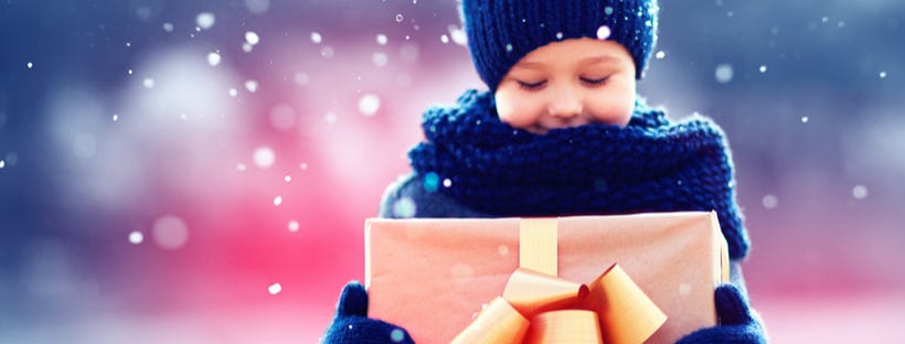 Little girl holding a gift wrapped box